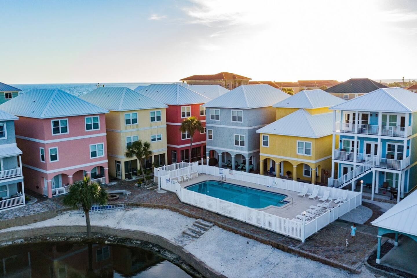 Rear view of Riviera Beach Villas, Panama Jane's, the pool, the pool side beach and the lake take from a drone.