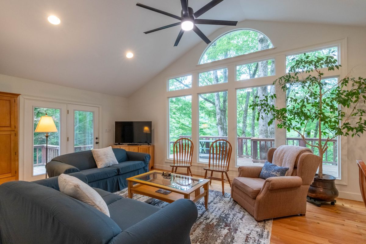 Living Room: Bright, airy space with nature views and plush seating for ultimate relaxation!

