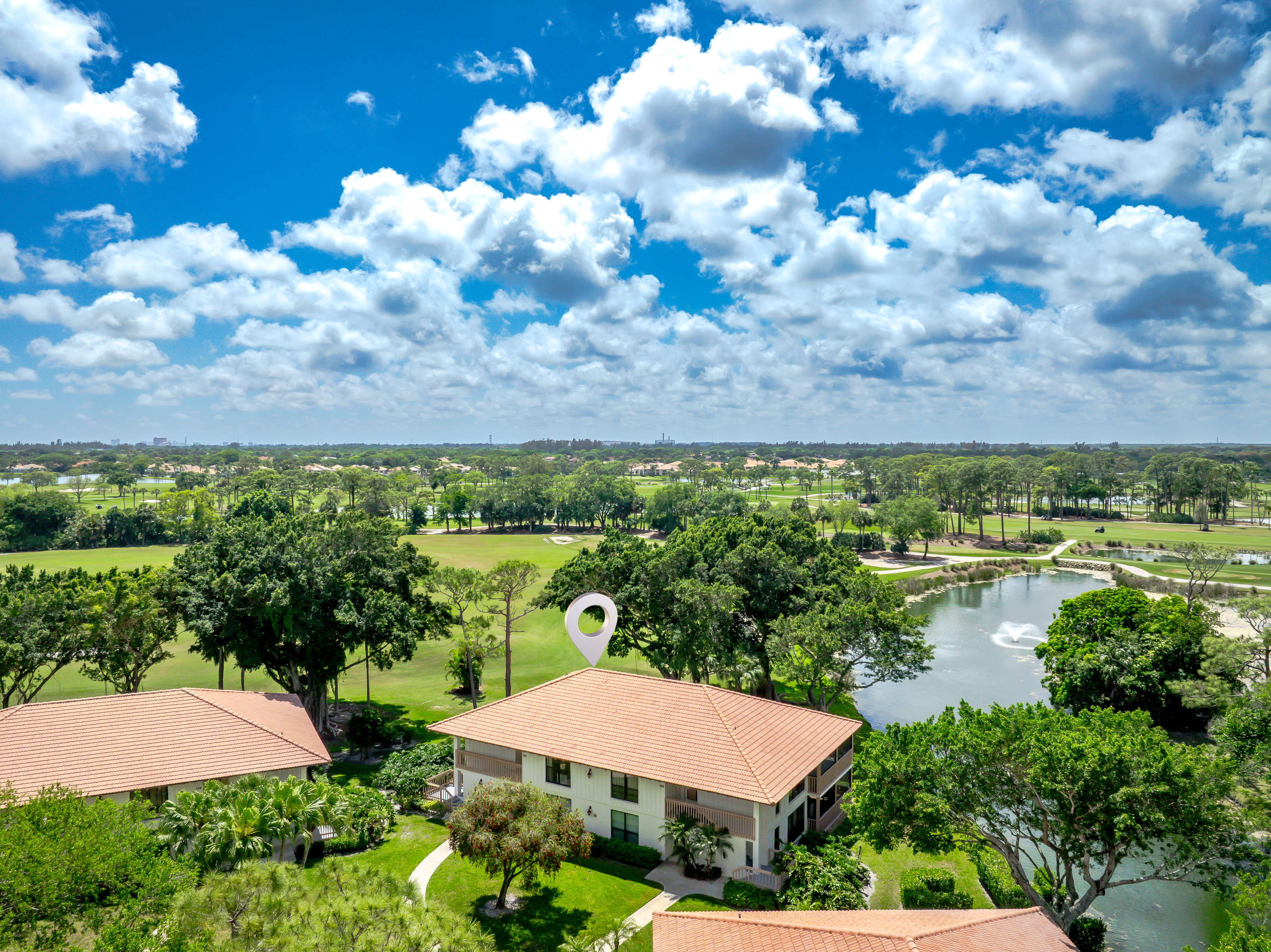 Aerial view showcasing lush golf course, water features, and serene surroundings