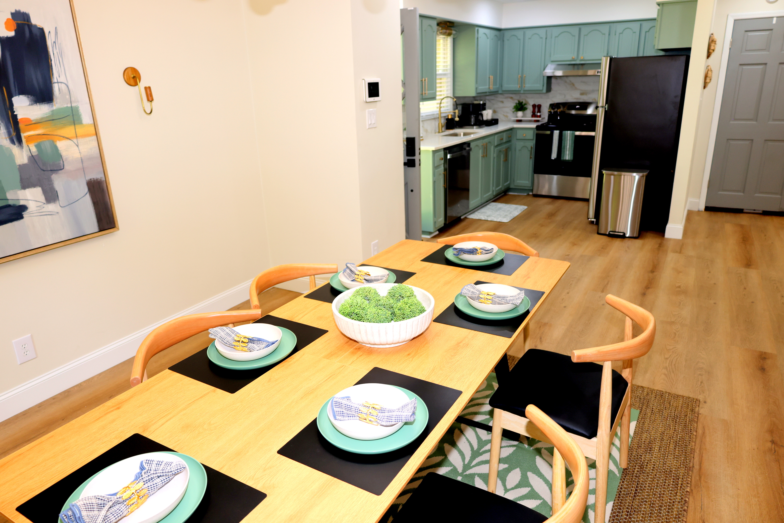 Dining area with a view into the updated kitchen, perfect for meals and gathering