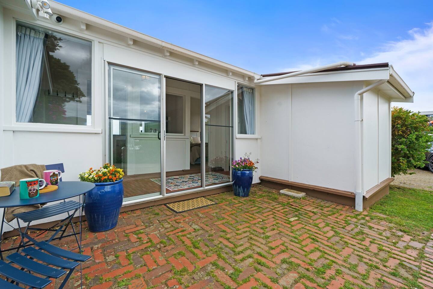 This is the front entrance into the Cottage.  In the courtyard to the left there is a cafe setting.  This area gets lots of lovely morning sun.  Perfect for your morning coffee.

Car parking is just to the right, easy access into the property.
