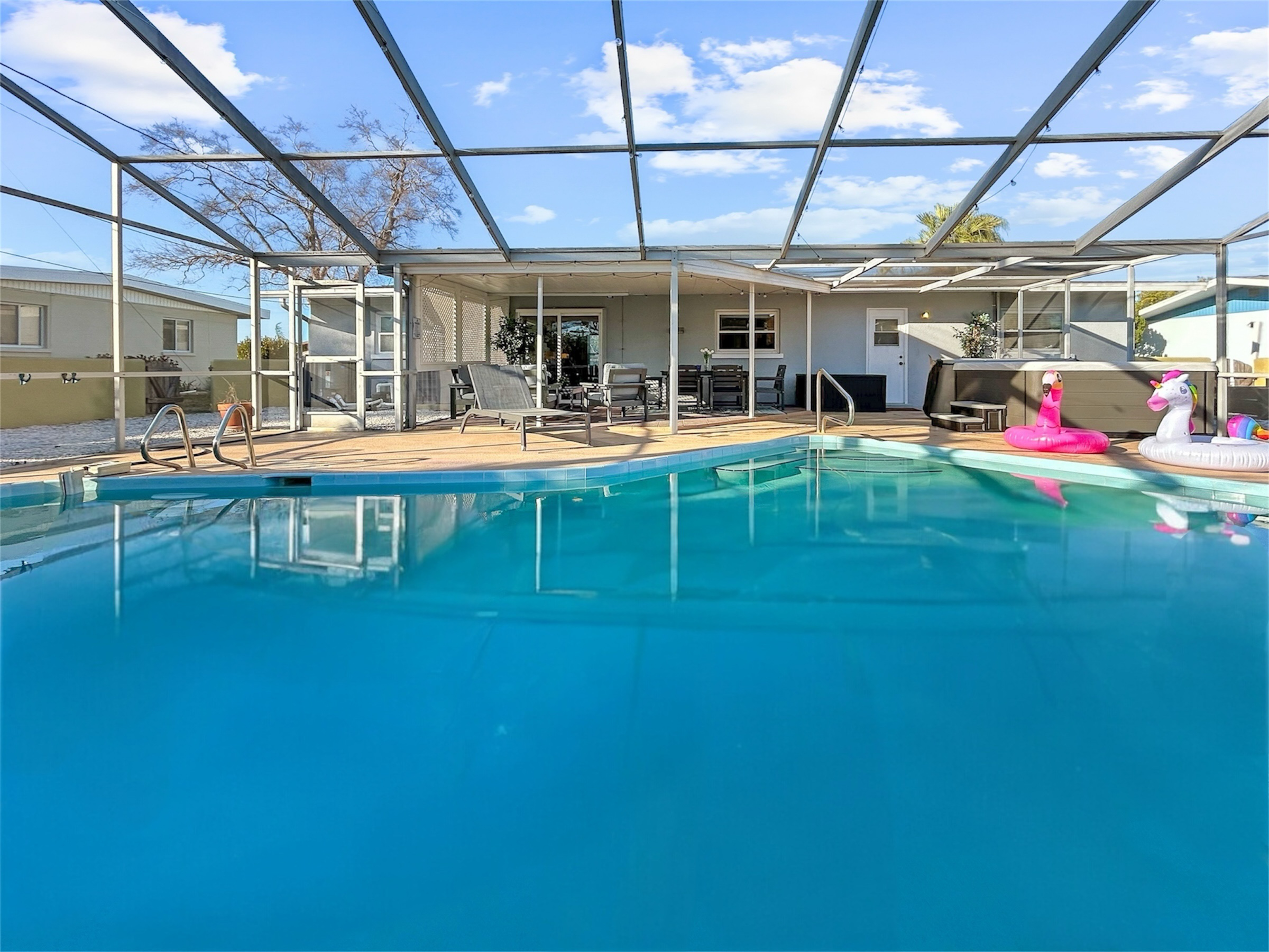 Sparkling private pool with a spacious patio setup—made for pool days, meals outside, and evening unwind.