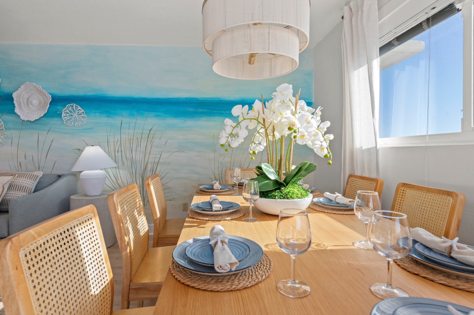 Gather around the sunlit dining table, where coastal views and breezy textures set the scene for lingering dinners, shared stories, and unhurried mornings together.