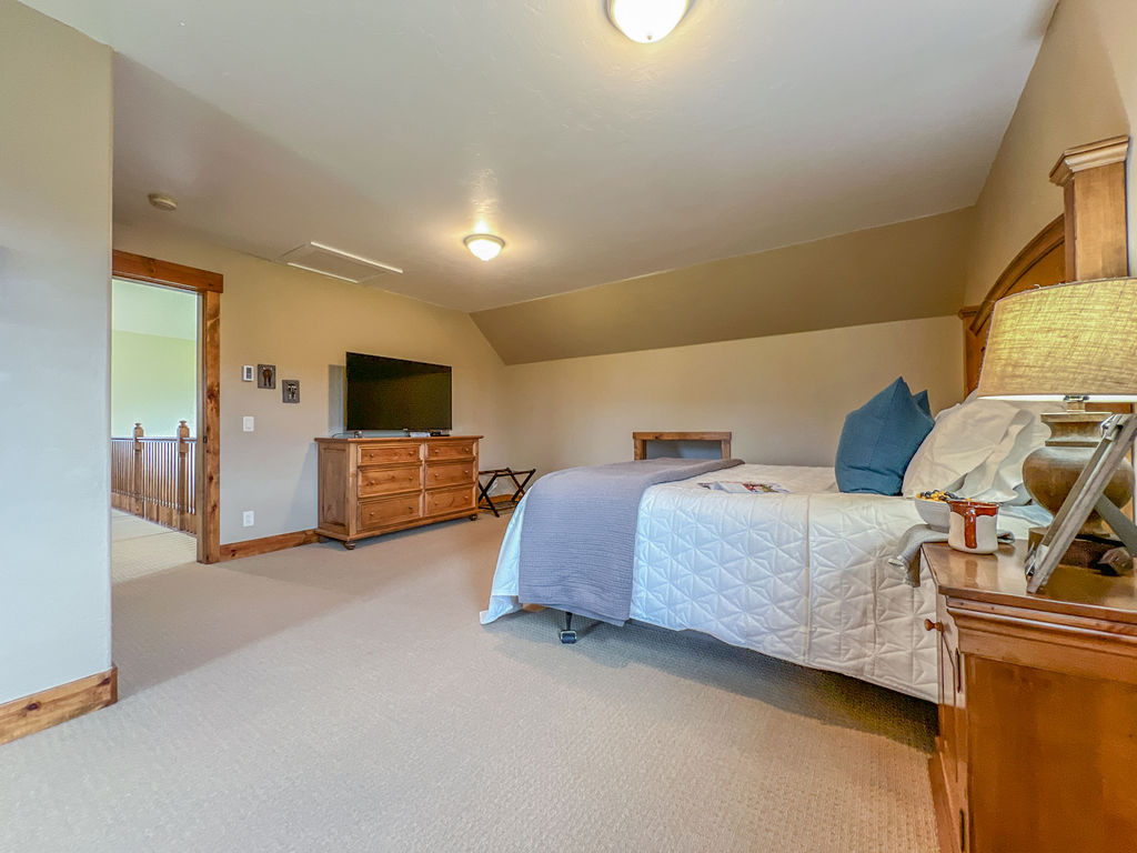 Featuring a spacious room and a large tv.
