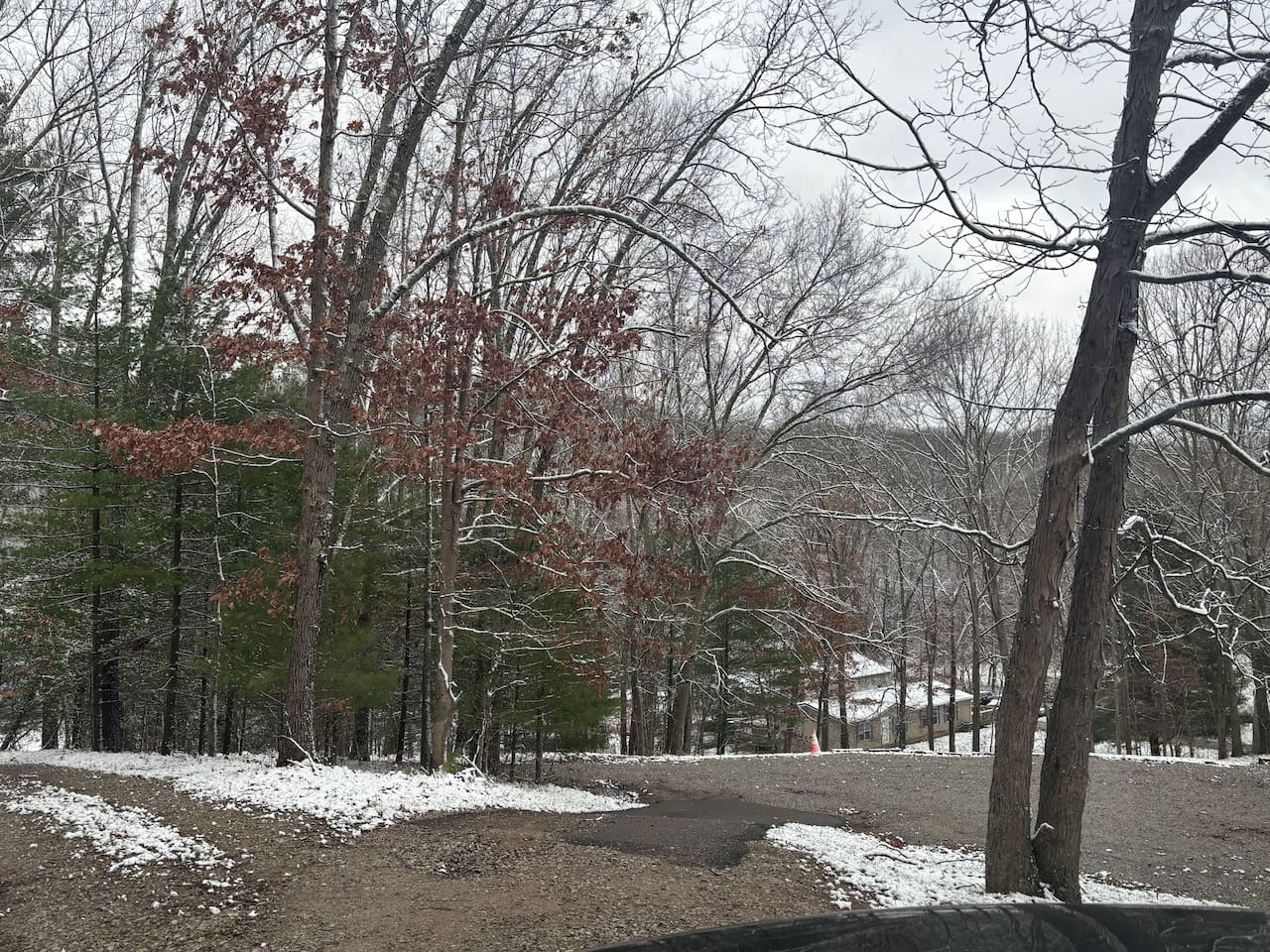 (the house is on the right side of this picture). This is a steep asphalted short hill to the parking lot. Or the left side is a graveled driveway with a lot you can park at as well. It can be tricky. 