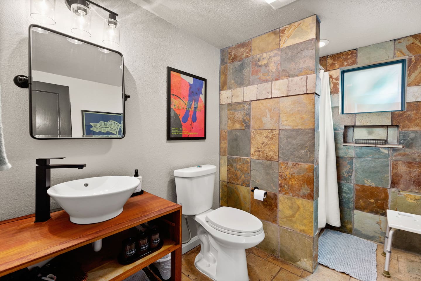 Bright and modern bath with walk-in shower and stocked toiletries with fresh towels always included.