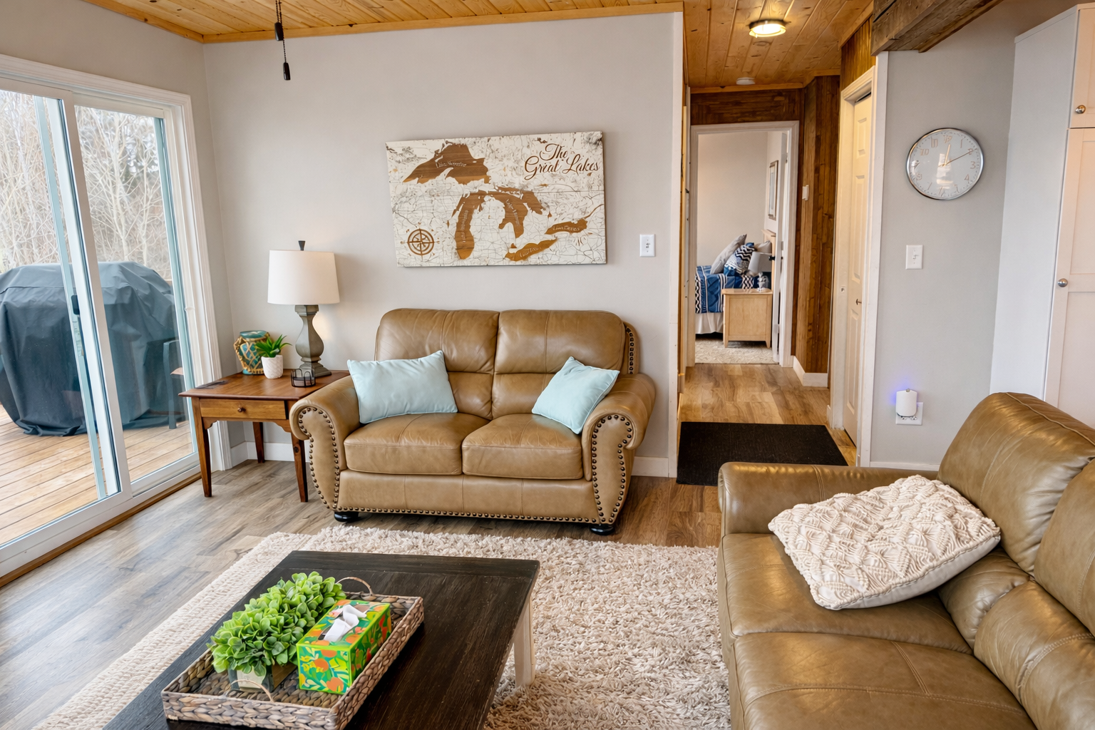 From the living room, you look back toward the bedroom and the front of the house, where you’ll find the stairs leading down to the basement. The open flow and cozy living space guide you naturally, making it easy to access both levels.