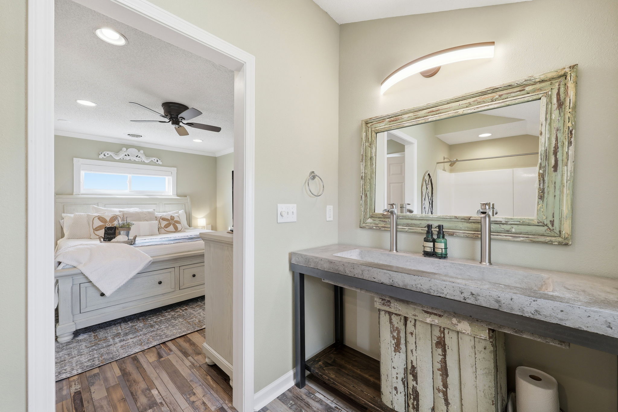 A one-of-a-kind rustic sink adds character to this thoughtfully designed ensuite bathroom
