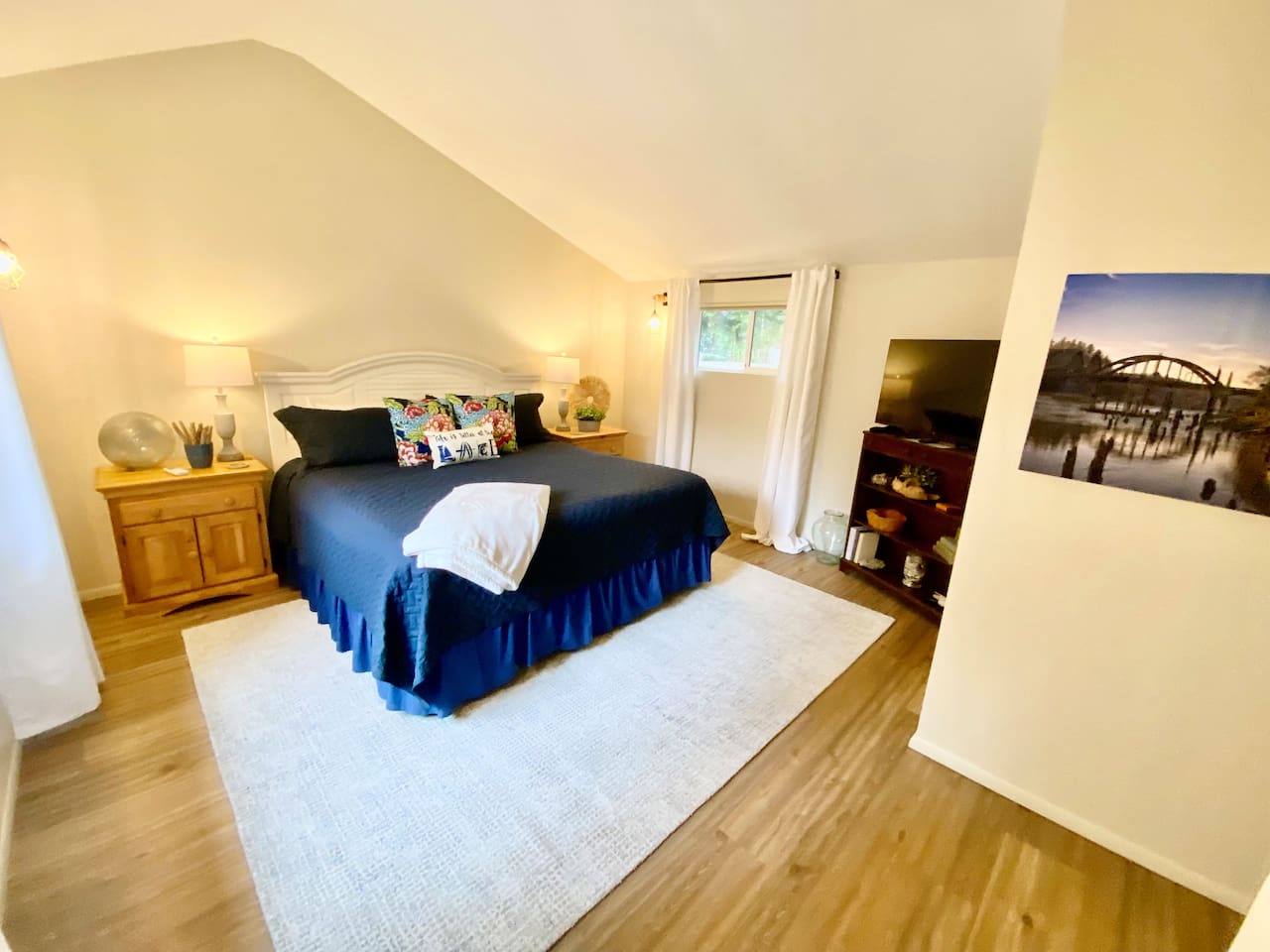 Primary bedroom with king bed and TV