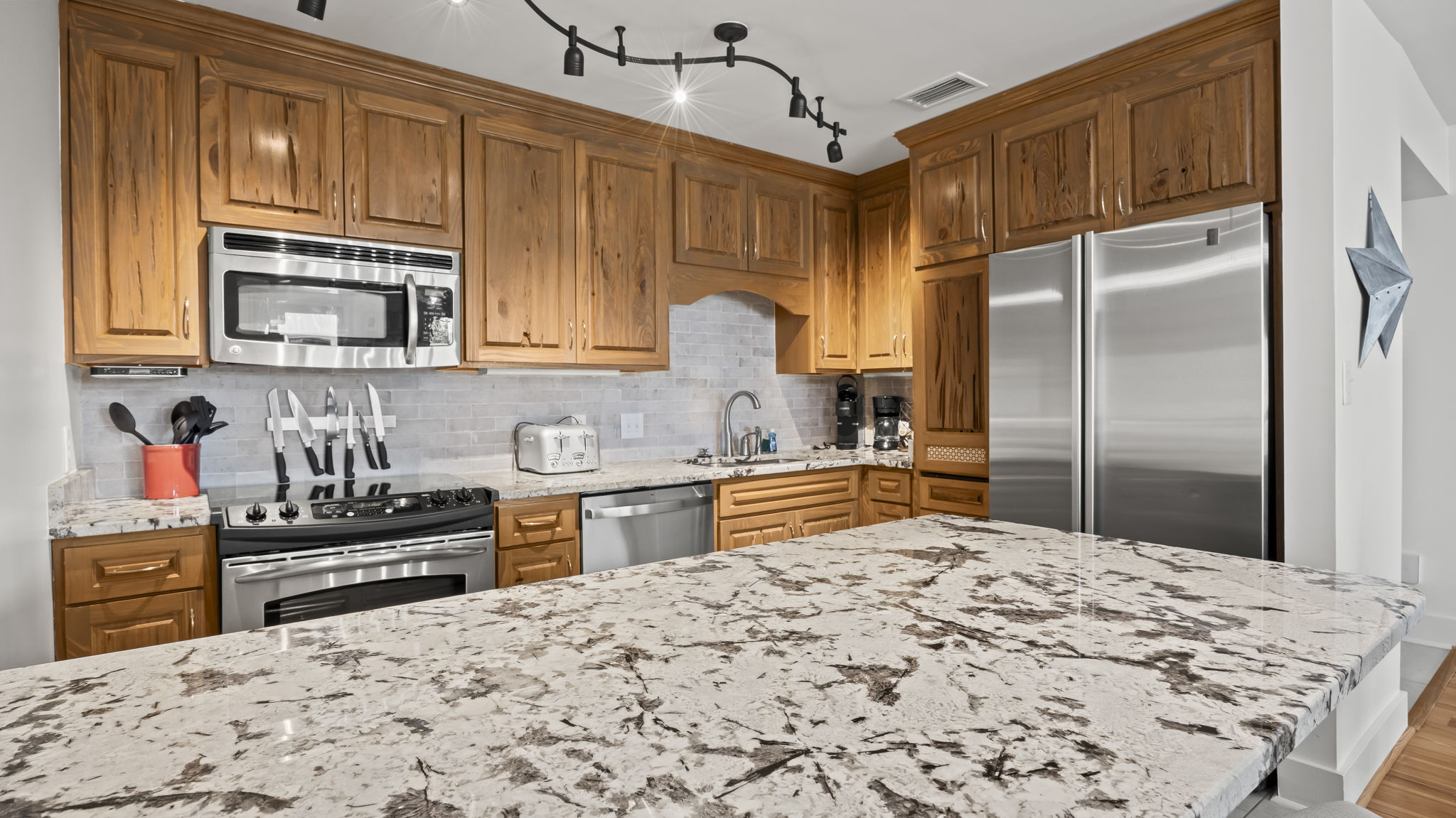 Cook with ease in the updated kitchen of our Cotton Bayou condo, featuring stainless steel appliances, an ice maker, a trash compactor, and a peninsula with extra seating. Fully stocked with all the essentials.