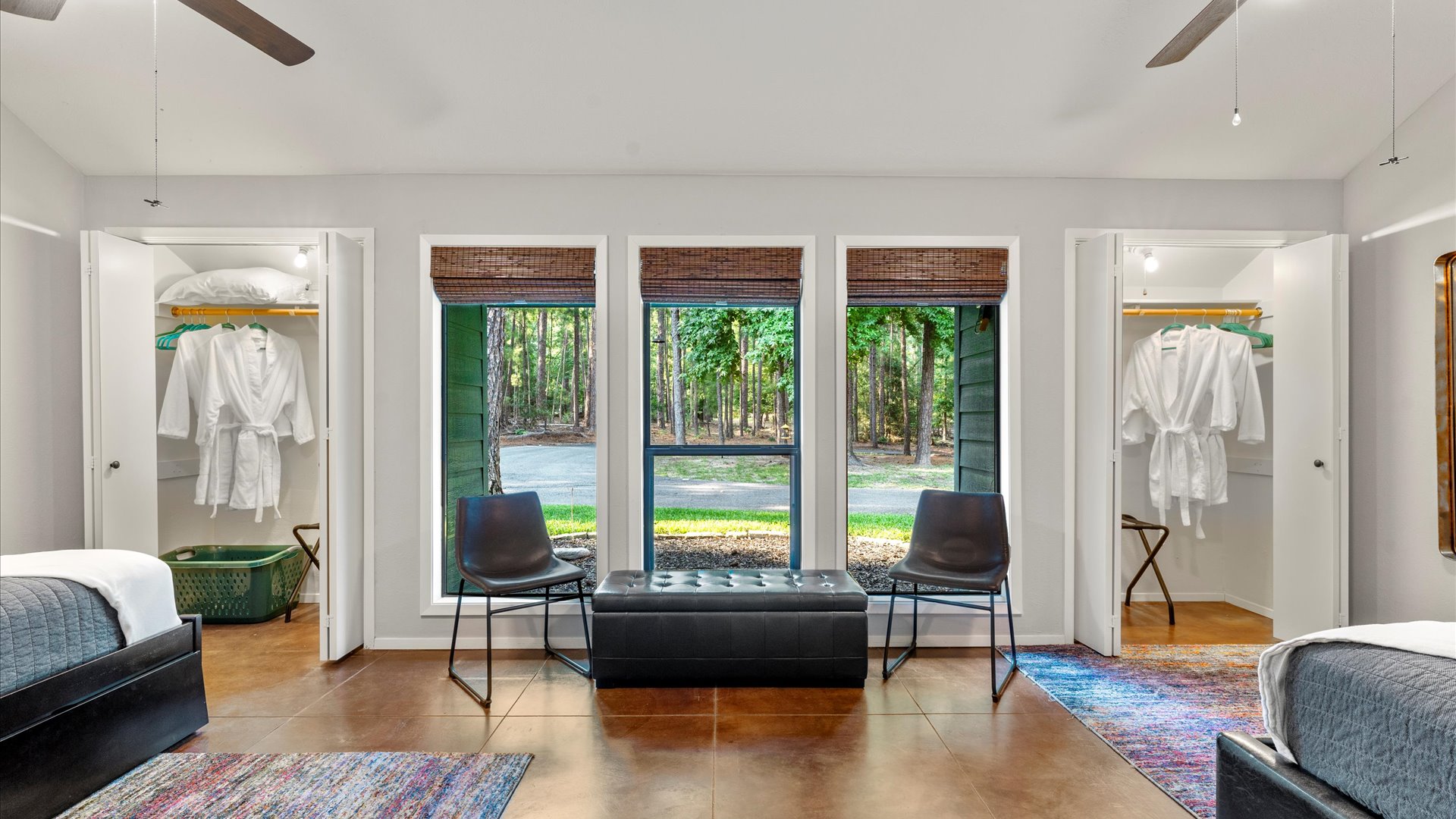 A bright and inviting view of the Trundle Bedroom! Featuring cozy seating, beautiful natural light, and well-appointed closets with plush robes, this space is designed for comfort and relaxation.