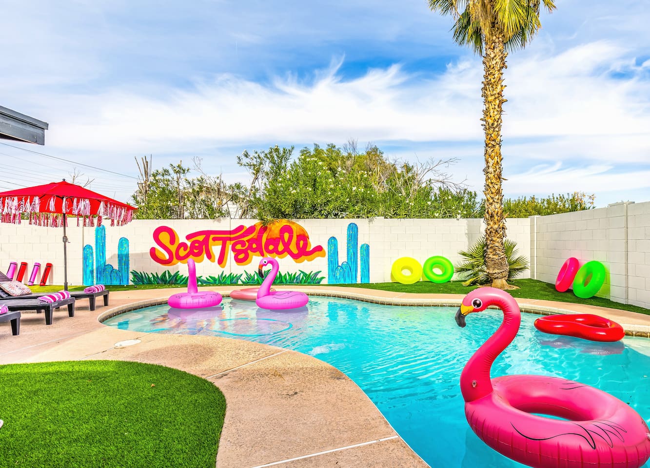 Dive into a fun-filled day with colorful float rings and sun-soaked poolside lounging.


