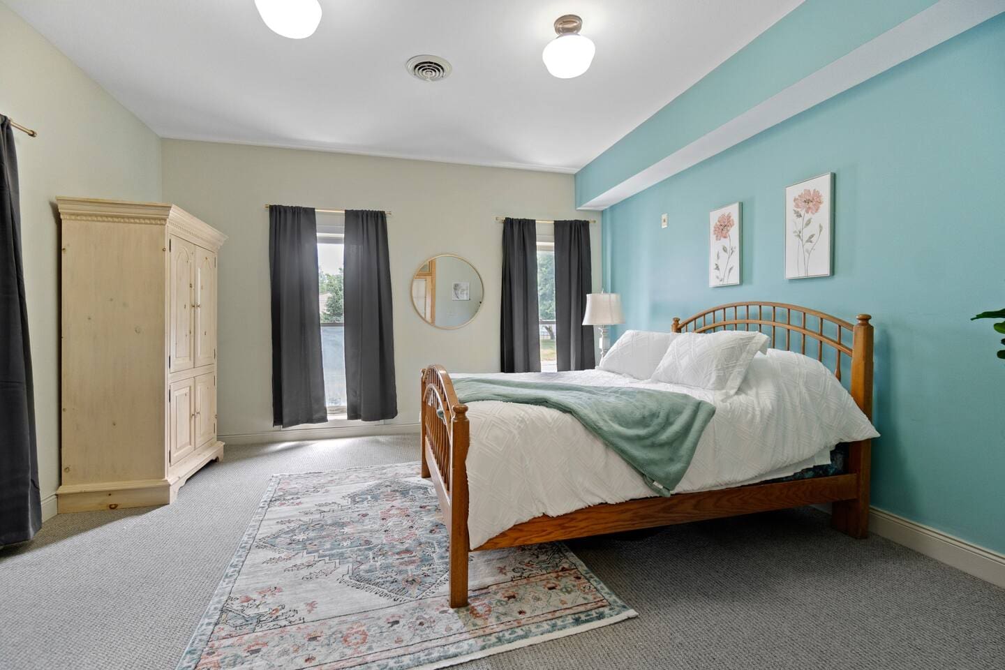 Spacious bedroom featuring a queen-sized bed, offering plenty of room for comfort and relaxation during your stay.