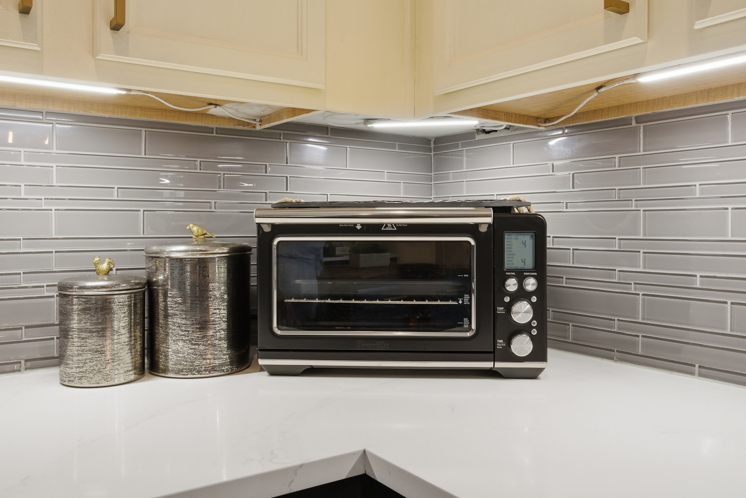 Toaster Oven with Air Fryer plus everyday cooking basics including a Toaster, Electric Kettle, and canisters on the counter.
