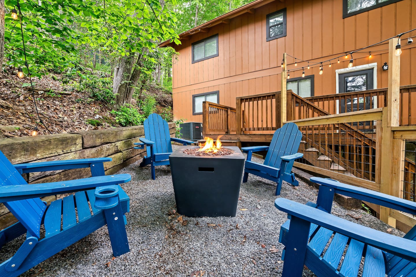 Propane fire pit is located two steps off the main level porch.