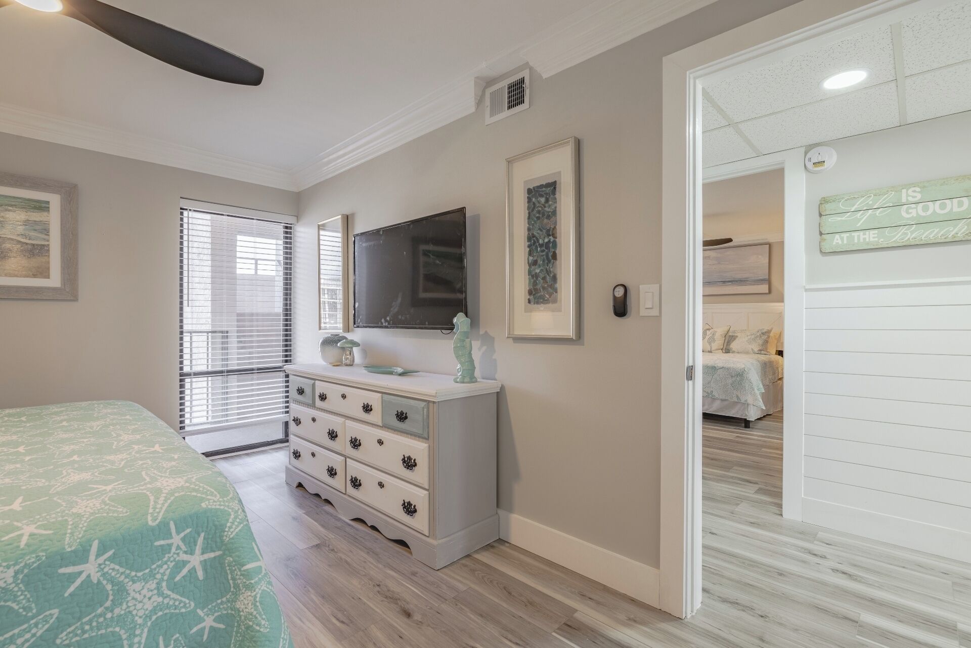 Master bedroom with king bed, ceiling fan, smart TV and ensuite bathroom