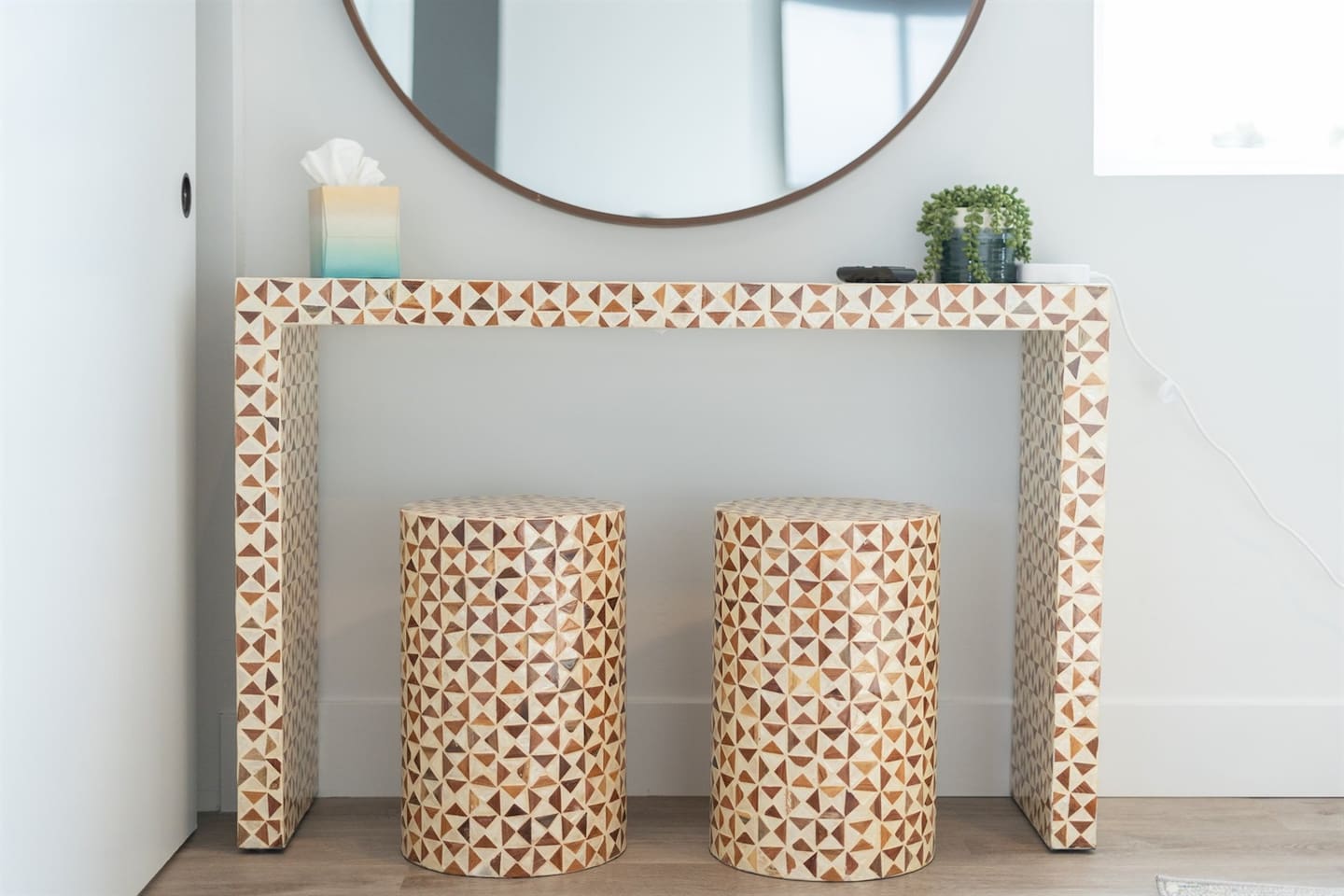 This chic vanity area includes a large mirror, a stylish chair, and a table, providing an inviting space for personal care and preparation, enhancing your daily routine.
