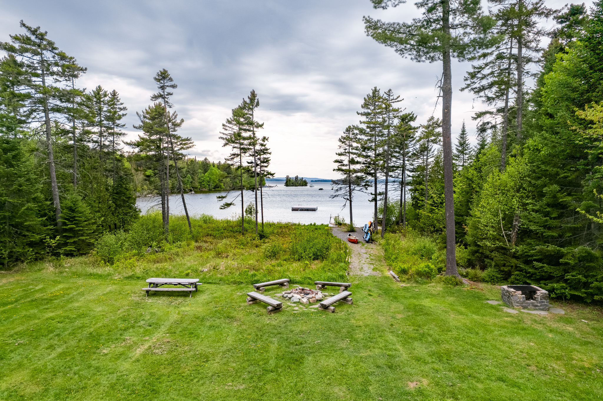 Escape to the back yard overlooking beautiful Lily Bay with amazing sunsets. Play a game of corn hole, gather by a crackling fire with 2 fire pits, or lounge by the your private dock and read a book. An enjoyable spot for everyone to hang out.