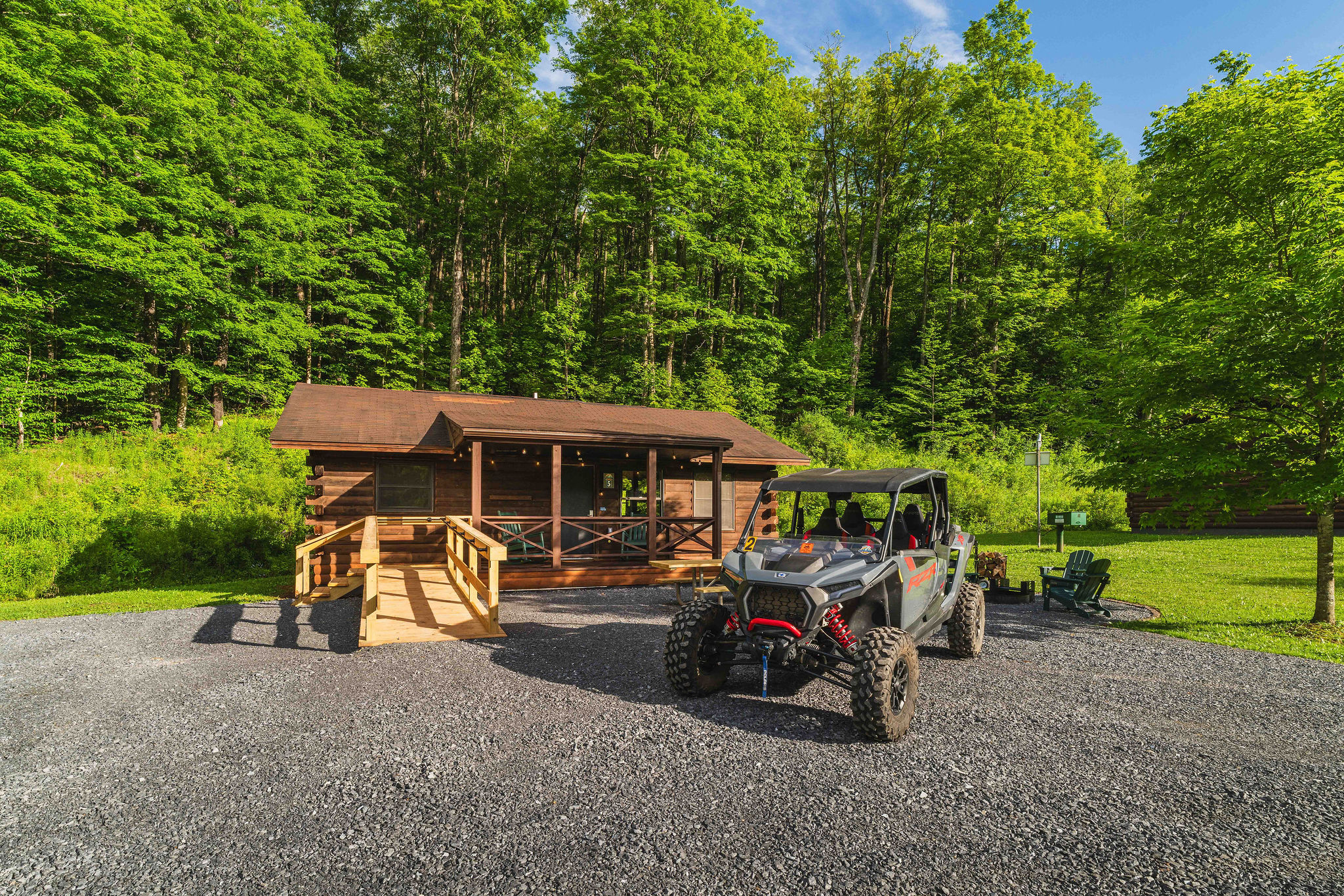 🛻 Park your UTV right at the cabin — trails start steps away. *(The UTV shown is not included — rentals available next door from our partners at Denton Go.)*