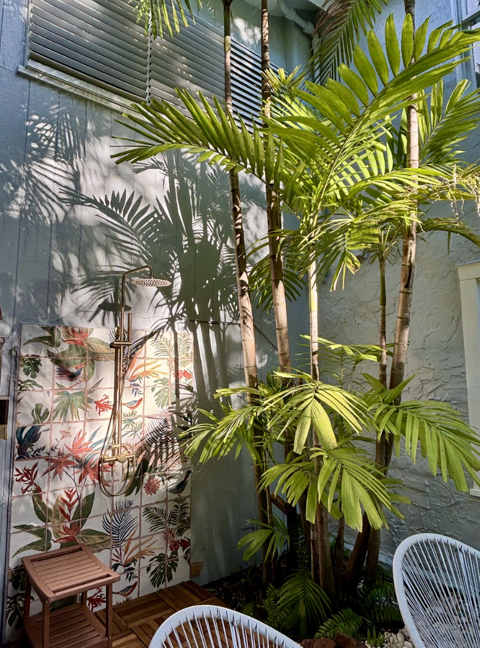 The picturesque outdoor shower has all the tropical vibes.