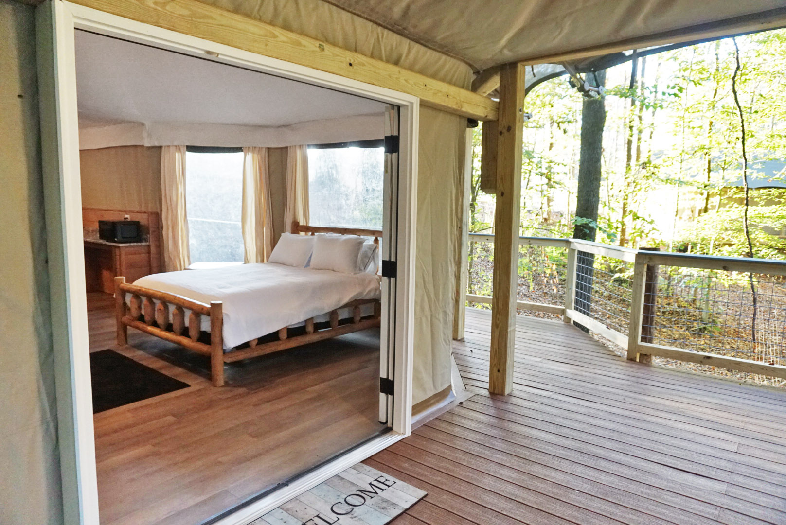 Embrace nature with a spacious bed and serene forest views from your private deck!