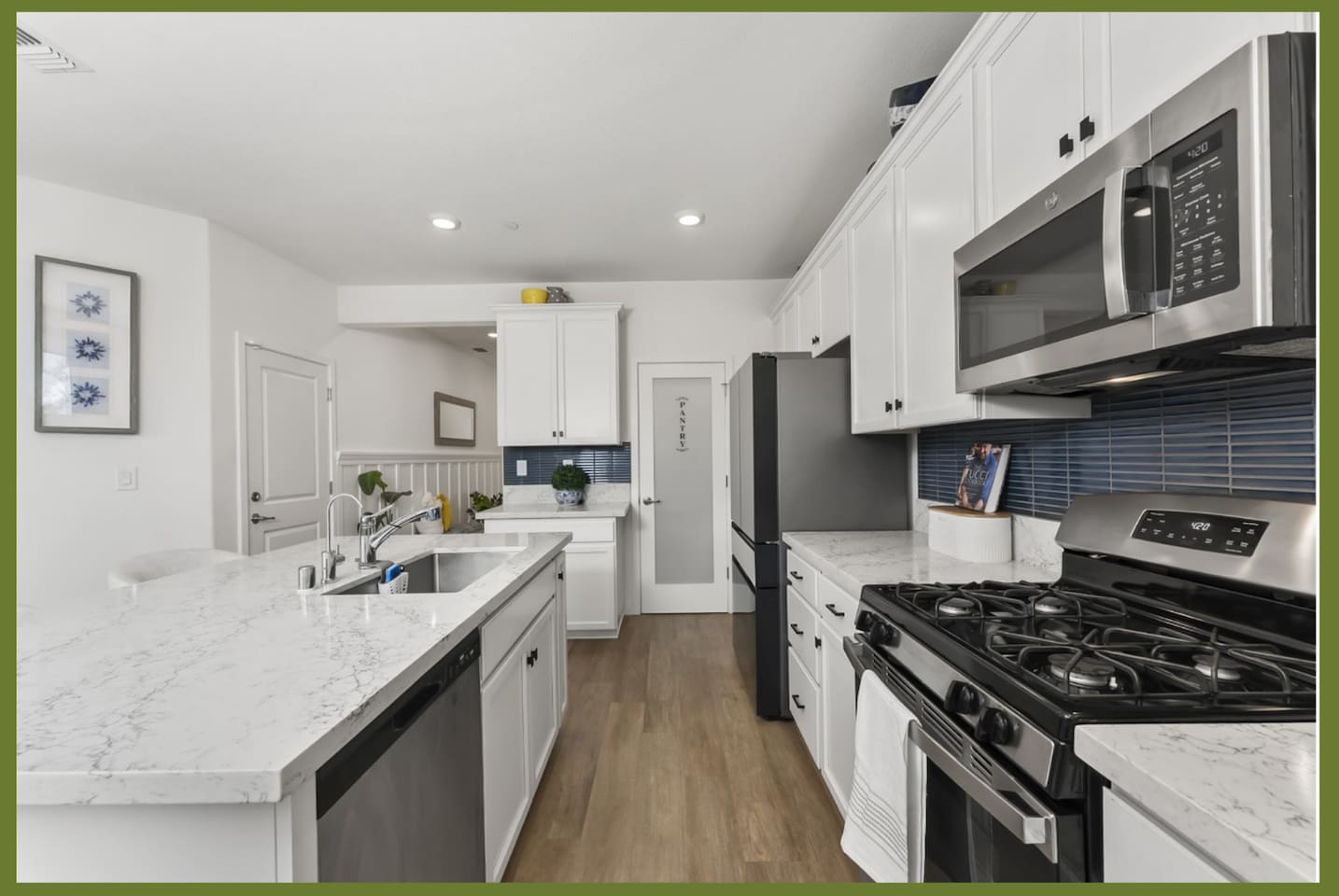 Kitchen with gas stove, stainless steel appliances, marble-style counters, and plenty of prep space for everyday meals.