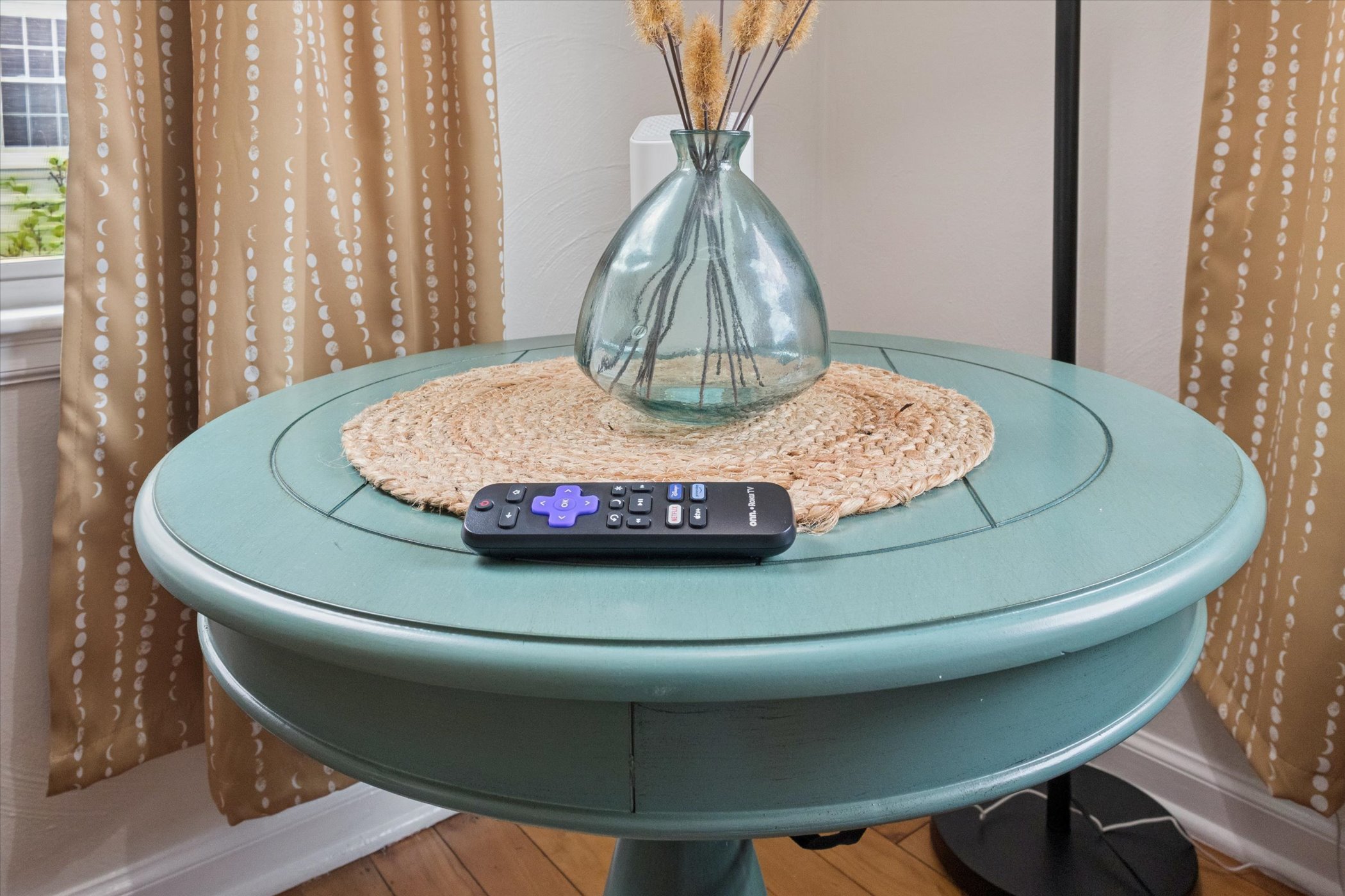 Captured on our teal table for the photo, but during your stay, Roku remotes live in the wall caddy below each TV. Every room features easy streaming with Roku-powered entertainment.