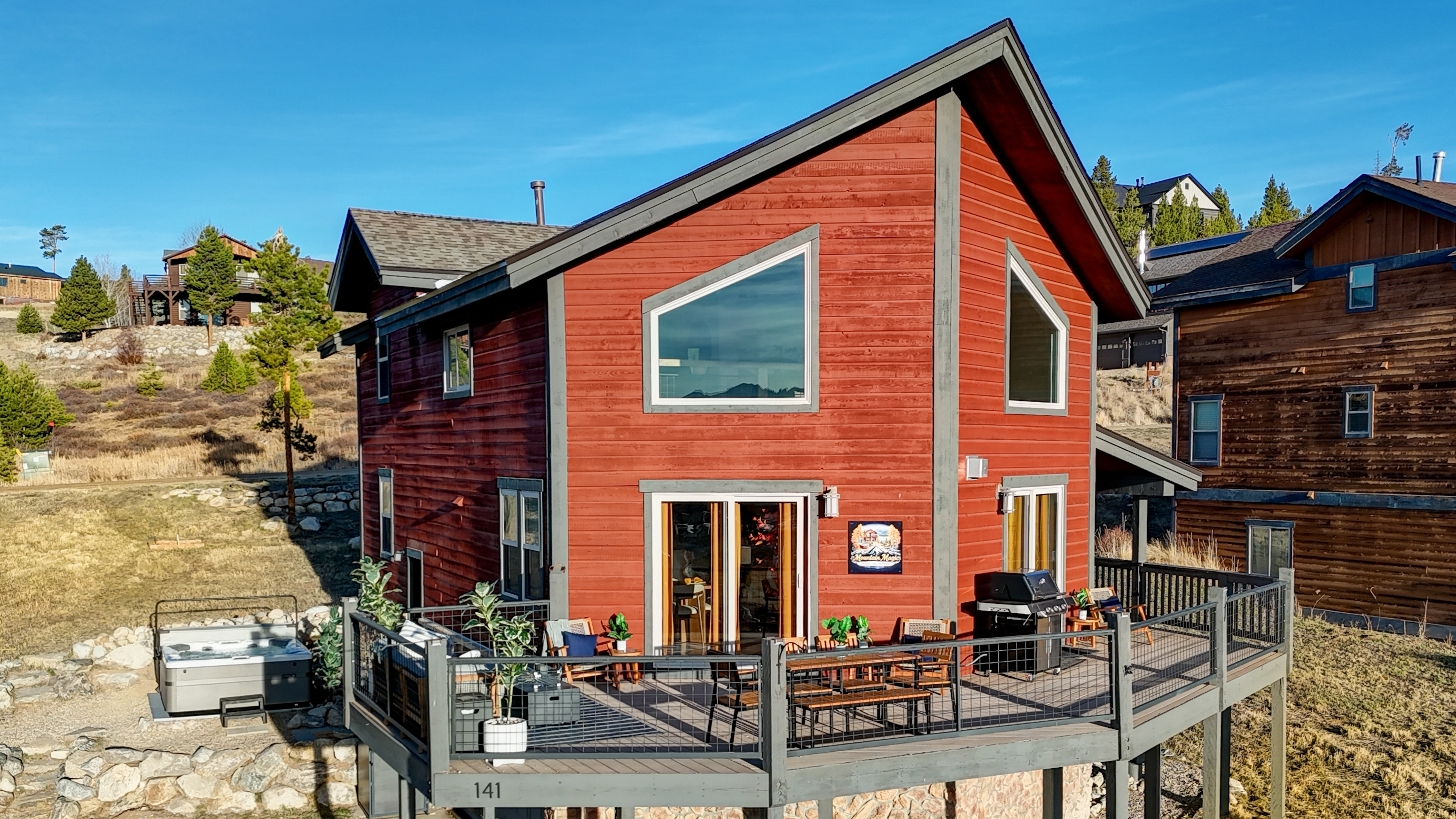 A striking red retreat nestled among the peaks—where upscale comfort meets rugged natural beauty.