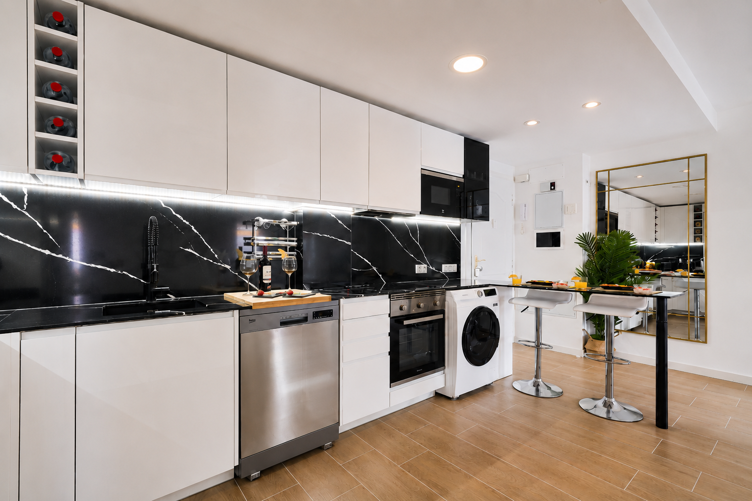 Modern, fully equipped kitchen with high-end appliances, elegant black quartz backsplash, and everything you need for a comfortable stay.