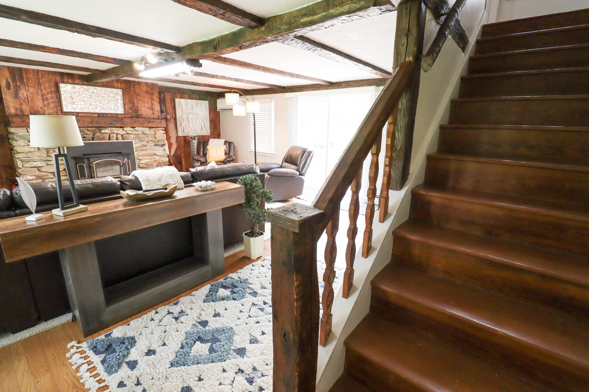 Warm, rustic staircase leads to comfortable accommodations, blending historic charm with modern amenities
