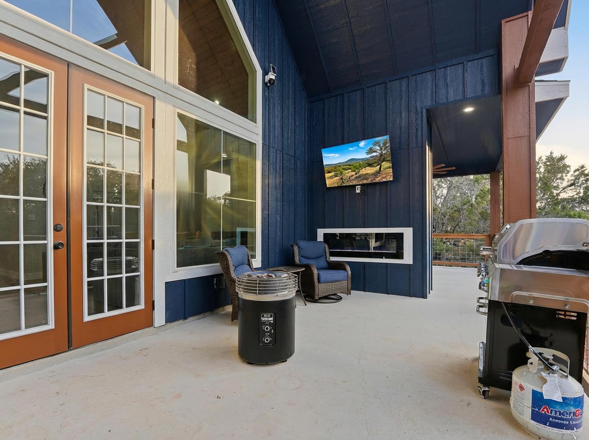 Covered outdoor living with BBQ, TV, and multiple seating zones for relaxed evenings together