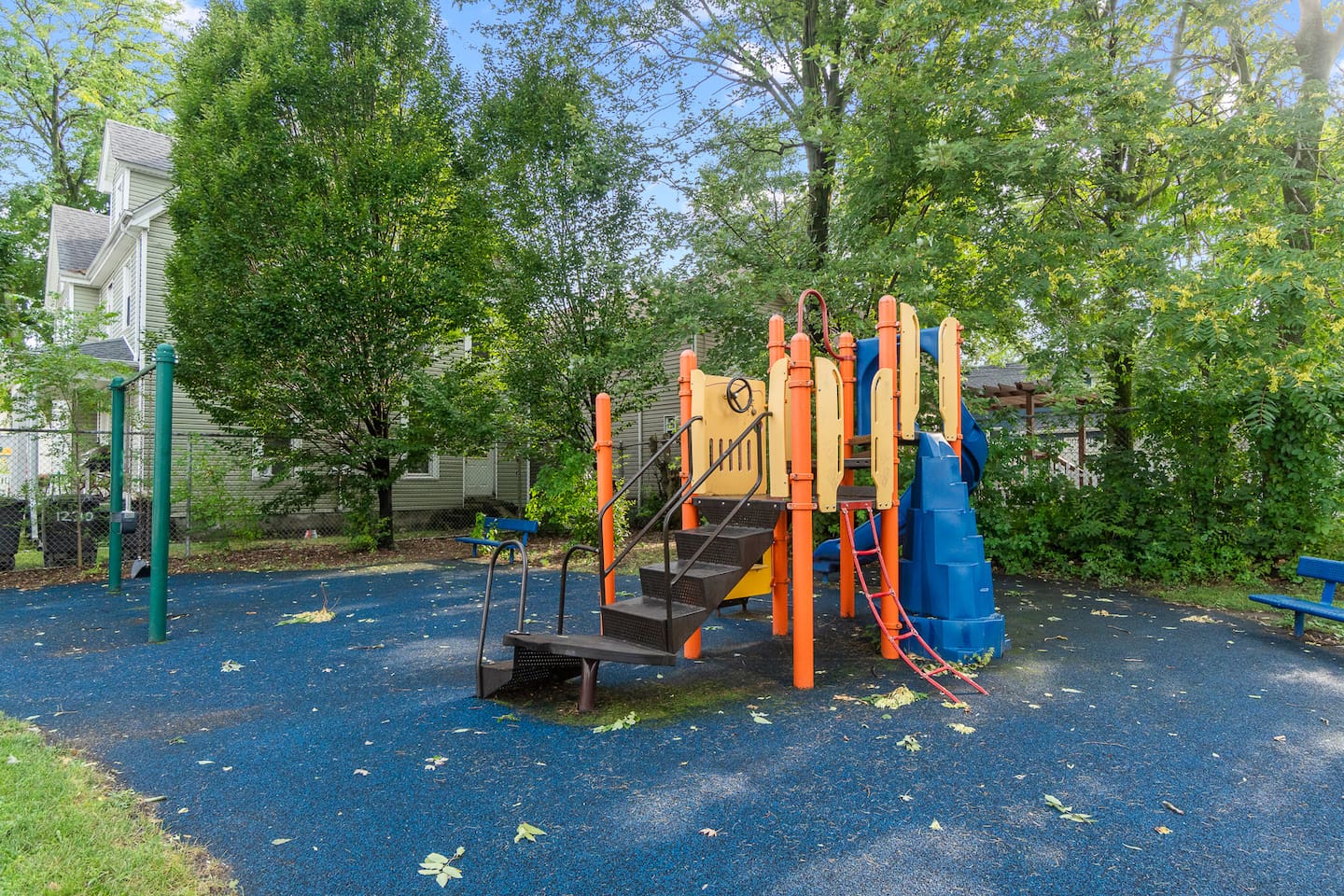 Playground with swings and play structure next to the backyard.