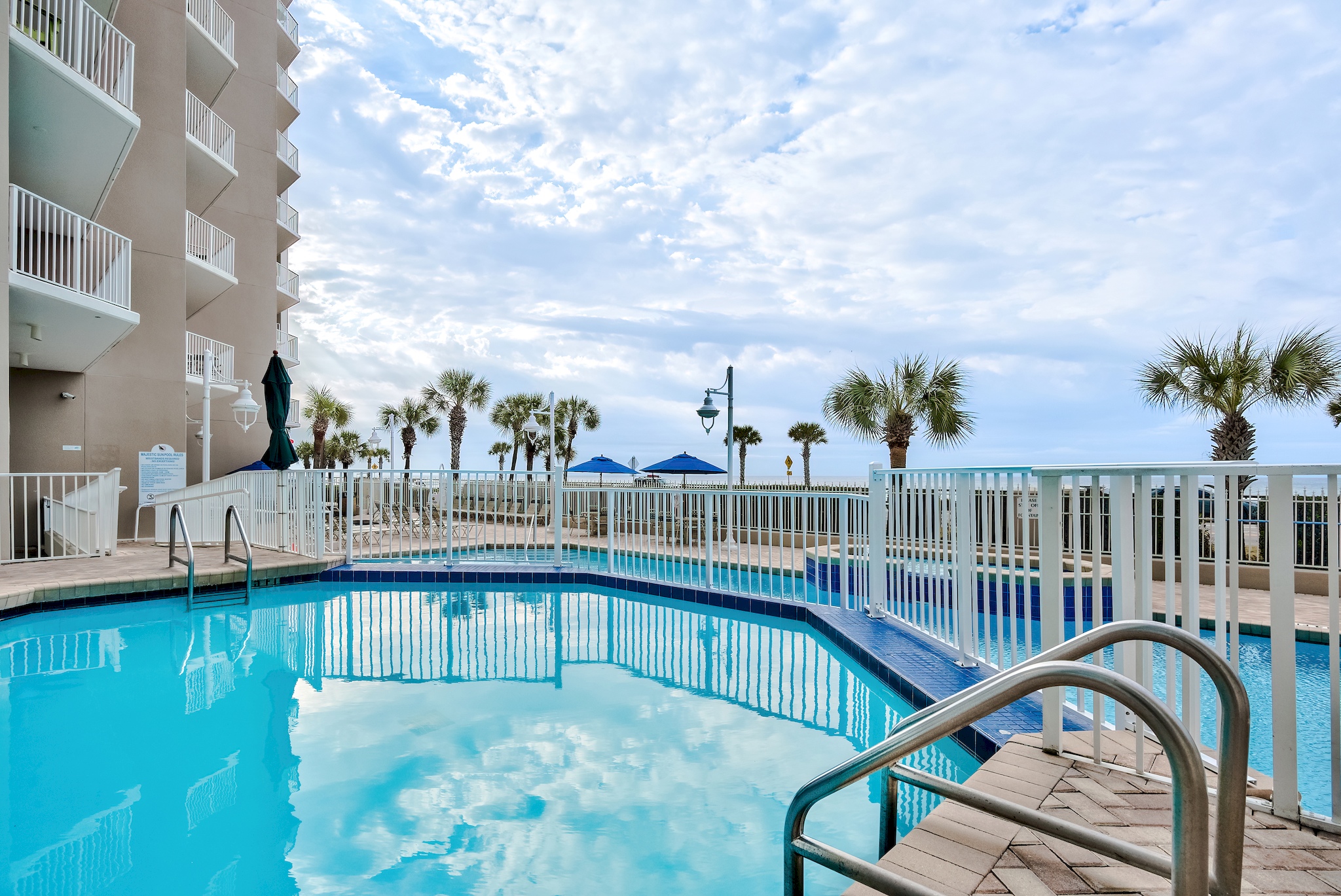 Majestic Sun has a large pool, two hot tubs on the elevated, and spacious patio with plenty of seating and shade overlooking the shimmering Gulf of Mexico.