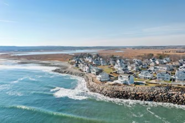 Bird’s-eye view of the house, backyard, and beautiful coastal setting.