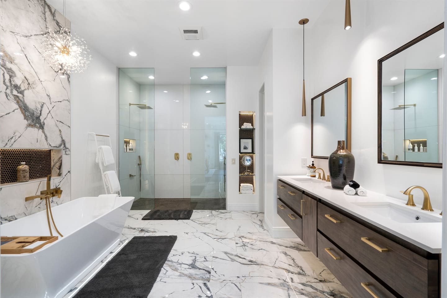 Indulge in spa-like luxury! Our elegant bathroom features a sleek walk-in shower, a modern soaking tub, and stunning marble accents. Perfect for relaxation and pampering during your stay
