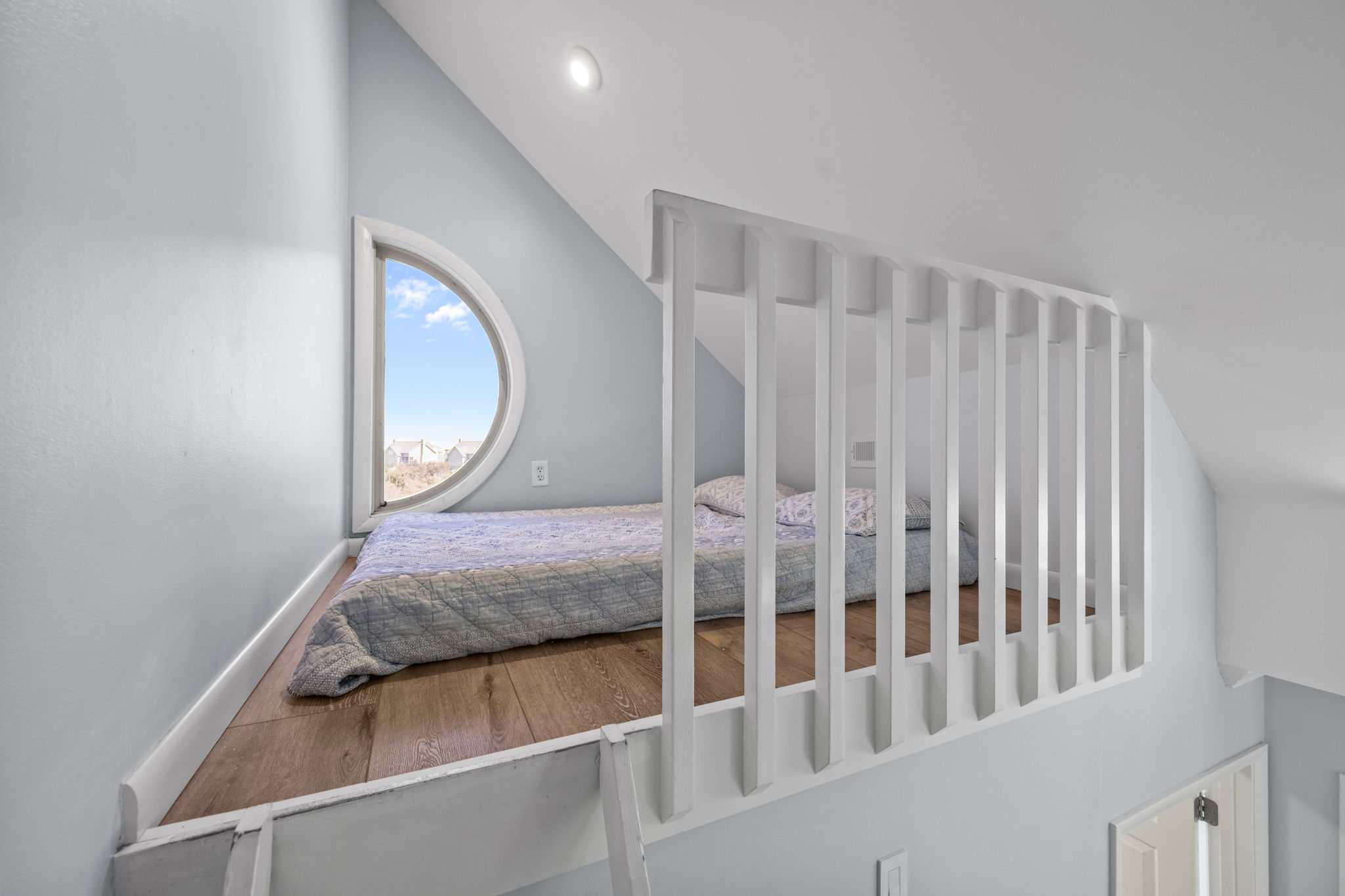 Cozy loft retreat with a full mattress, perfect for extra guests or a quiet reading nook.
