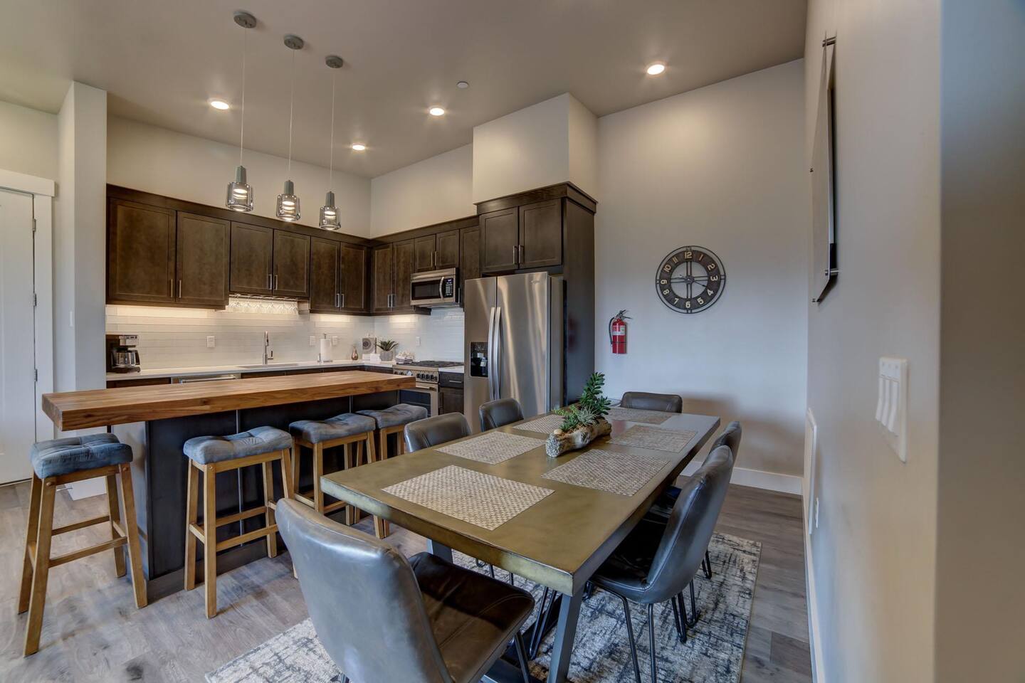 Open concept full kitchen with bar and dining table seat 10