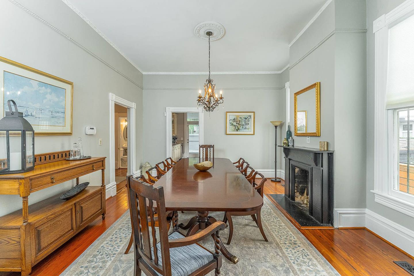 Entertain family and friends in the dining room with towering 11+ foot ceilings.  The long dining room table is perfect for gathering together and making lasting Savannah memories.