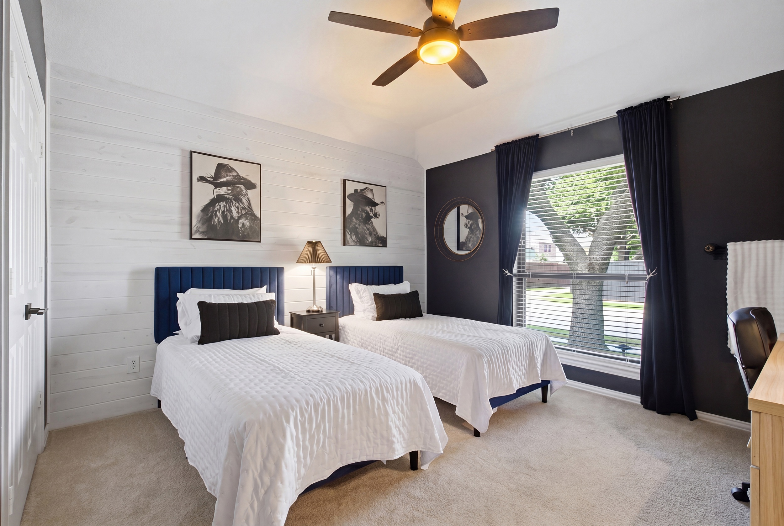 Guest Bedroom 3 with 2 Twin Beds, navy and white accents, and Western-inspired art. Sleeps two and works perfectly for kids or solo travelers.
