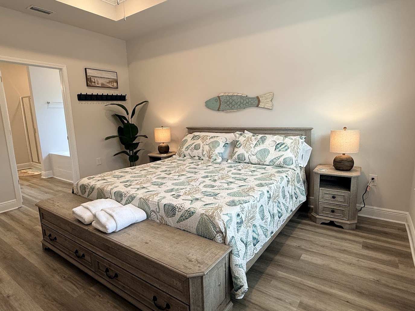 Serene primary suite with a king bed and calming coastal décor. Relaxing retreat with a comfortable king bed and smart TV.
