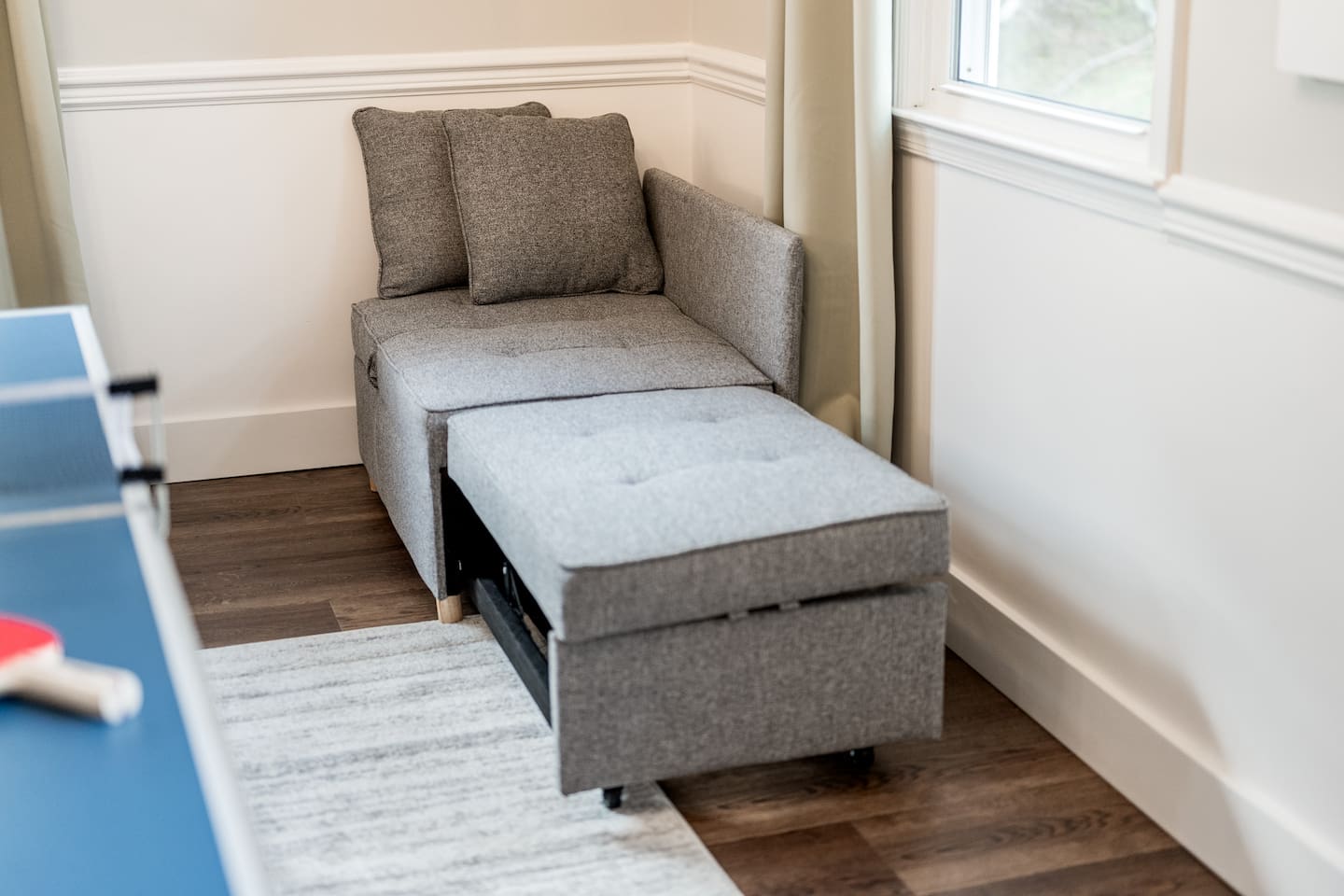 This corner chair converts into a small bed for a child.