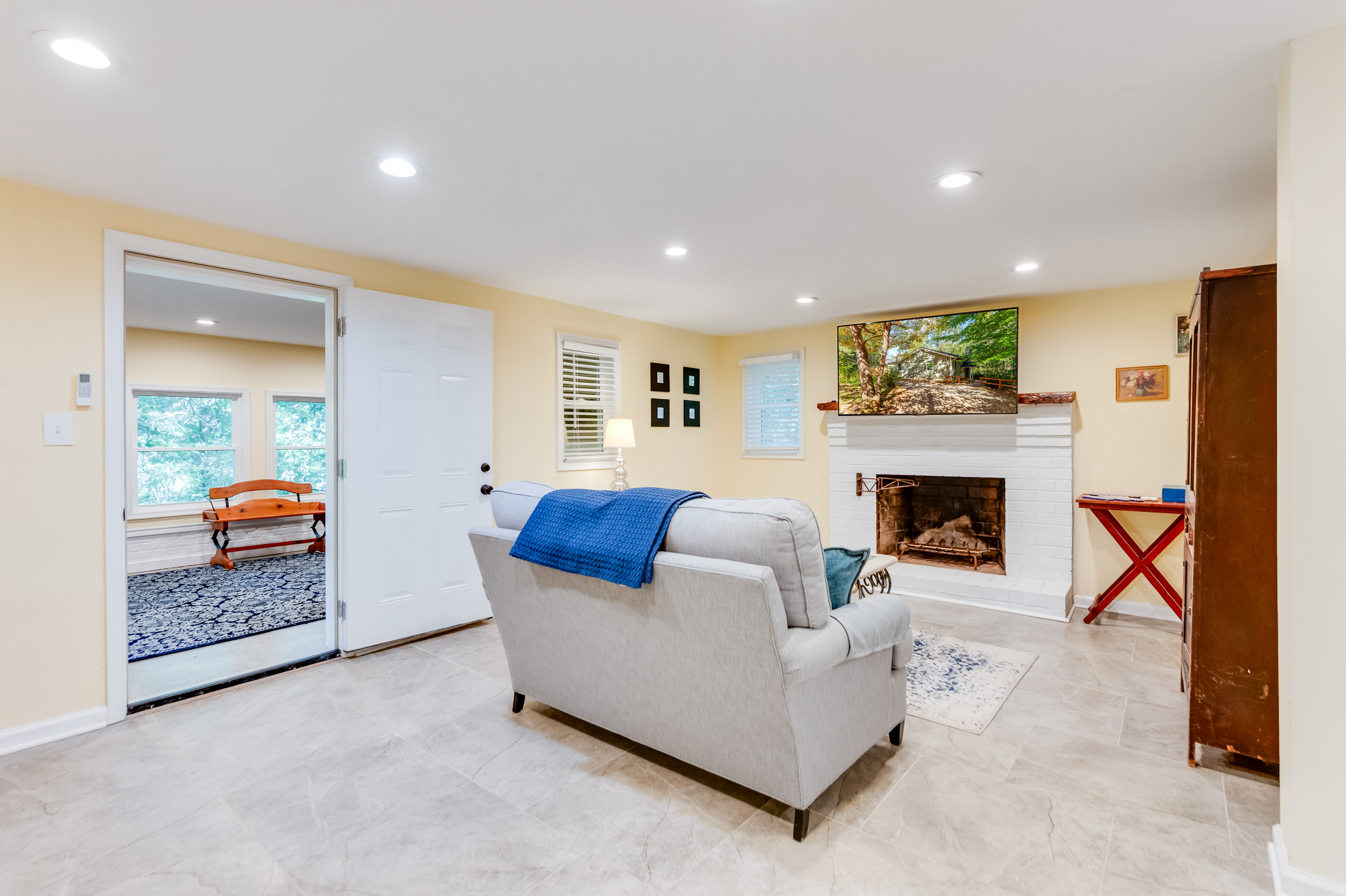 Downstairs Living Room: Bright and inviting space with a fireplace and scenic views for relaxation!