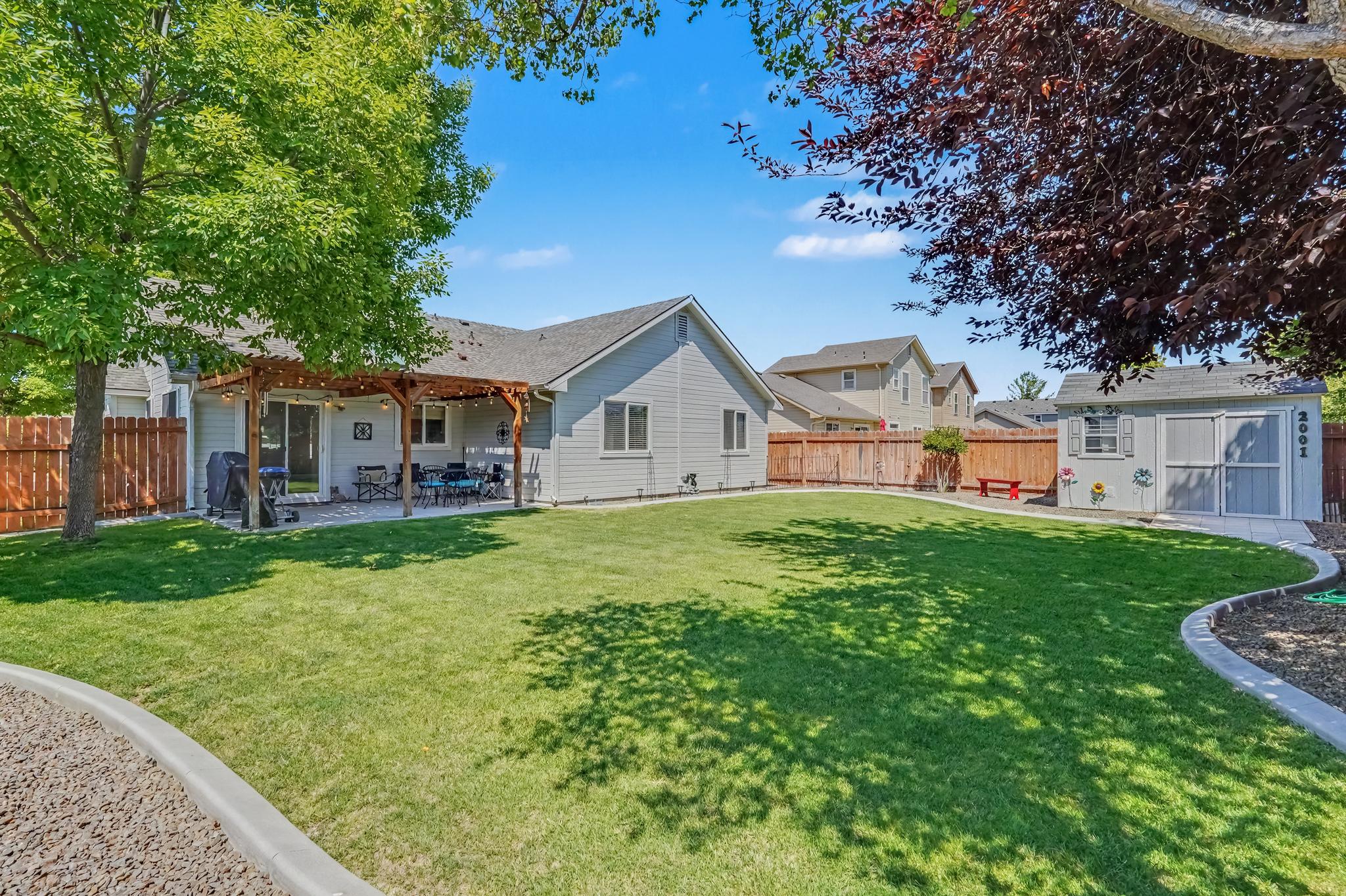 Step outside and enjoy the spacious, beautifully maintained backyard, designed for relaxation and outdoor fun. The covered patio is furnished with charming bistro lights, comfortable seating, and a BBQ grill, making it the perfect place to gather for meals