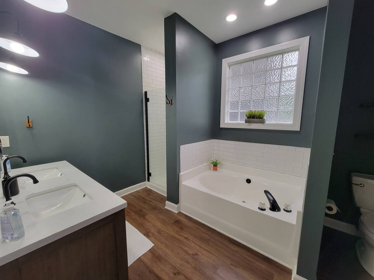 Master bathroom with tub, shower, and dual vanities