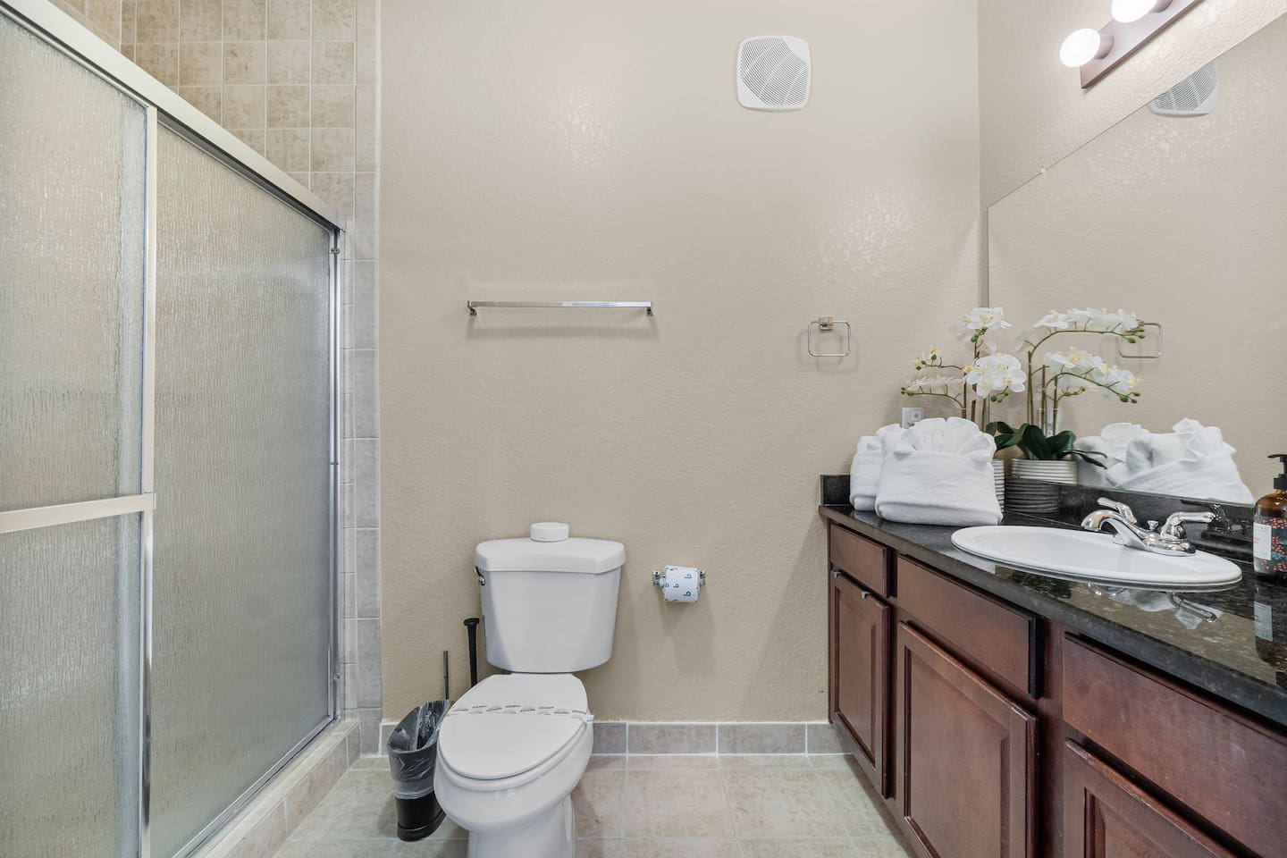 Full bathroom 1 with a large vanity and a walk in shower.