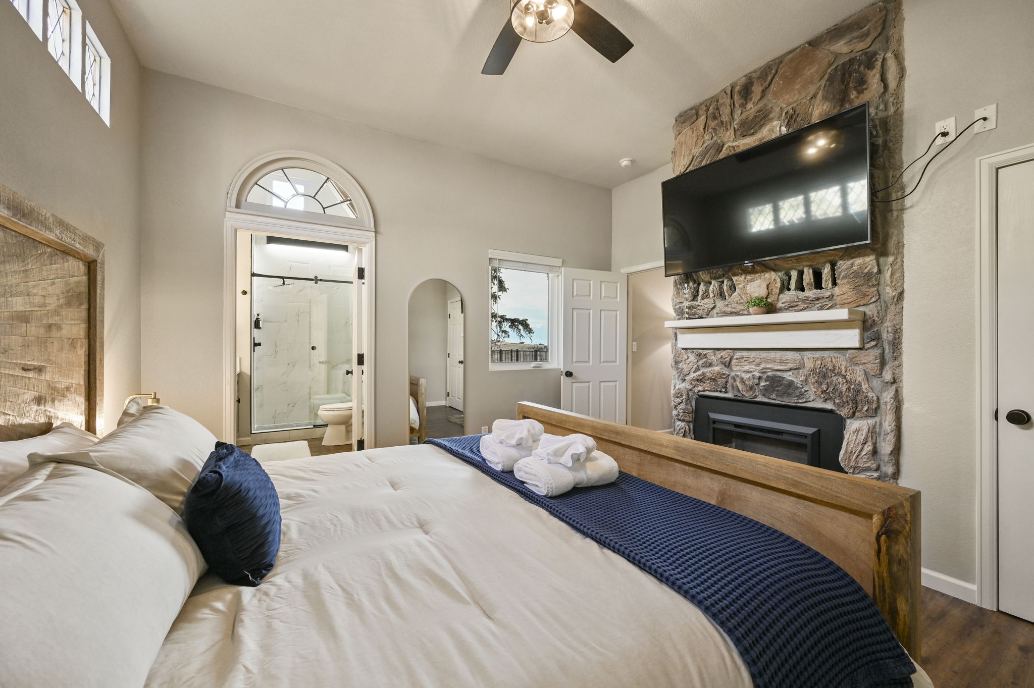 Bedroom 1 has a king bed, electric fireplace, and fabulous ensuite bathroom
