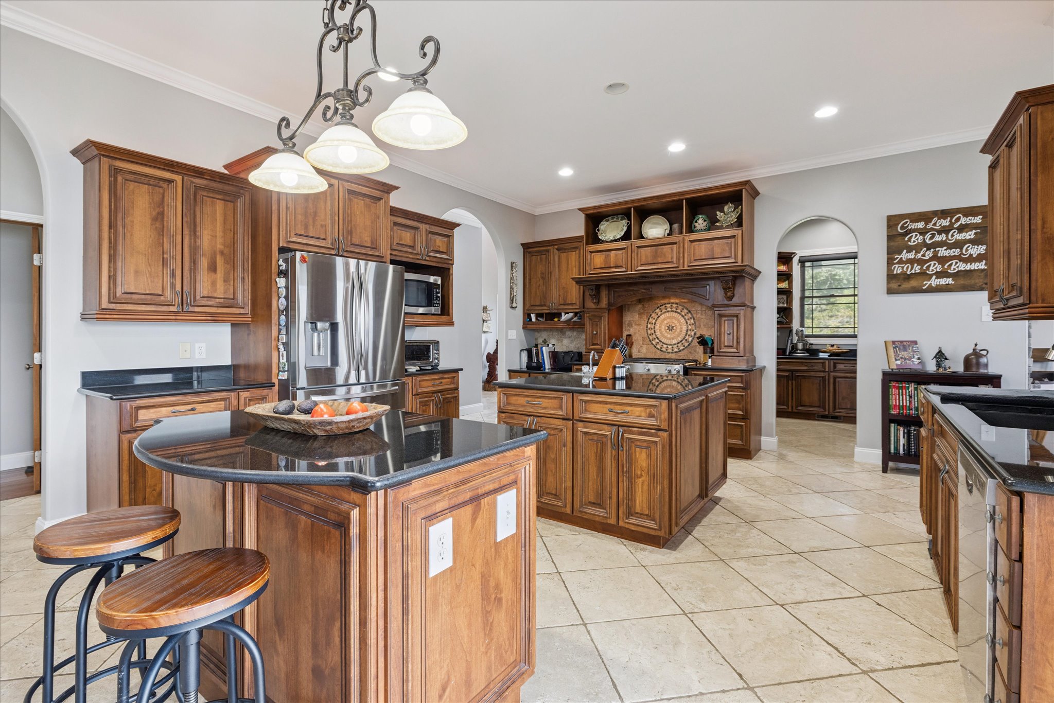 Looking backward to Massive Kitchen with 2 sinks, an eating area, and large pantry