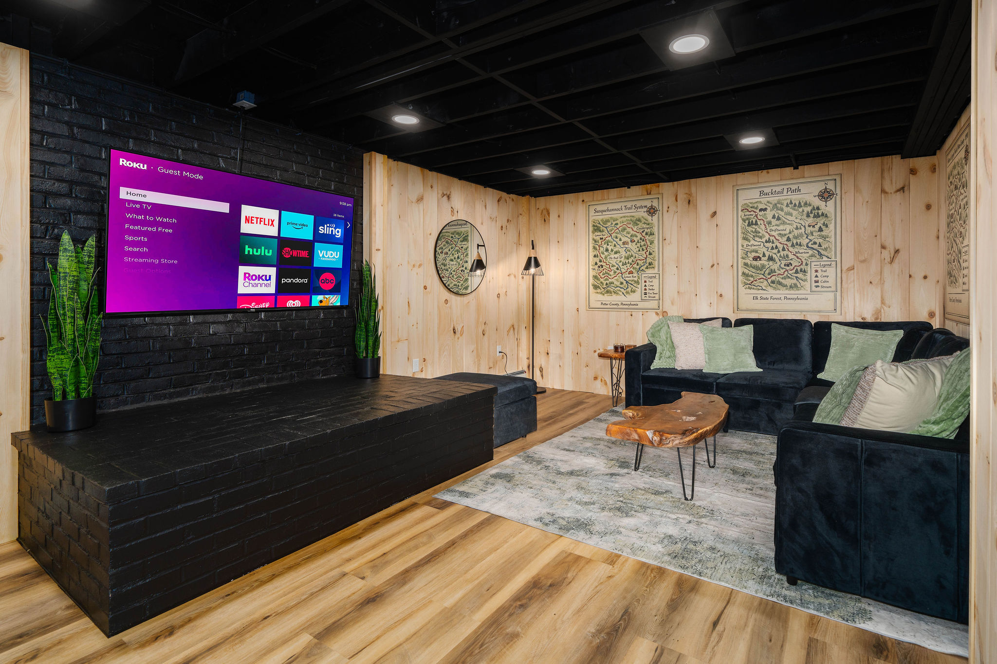 📺 A 65" TV and sectional that seats eight — the ultimate movie-and-game cave.