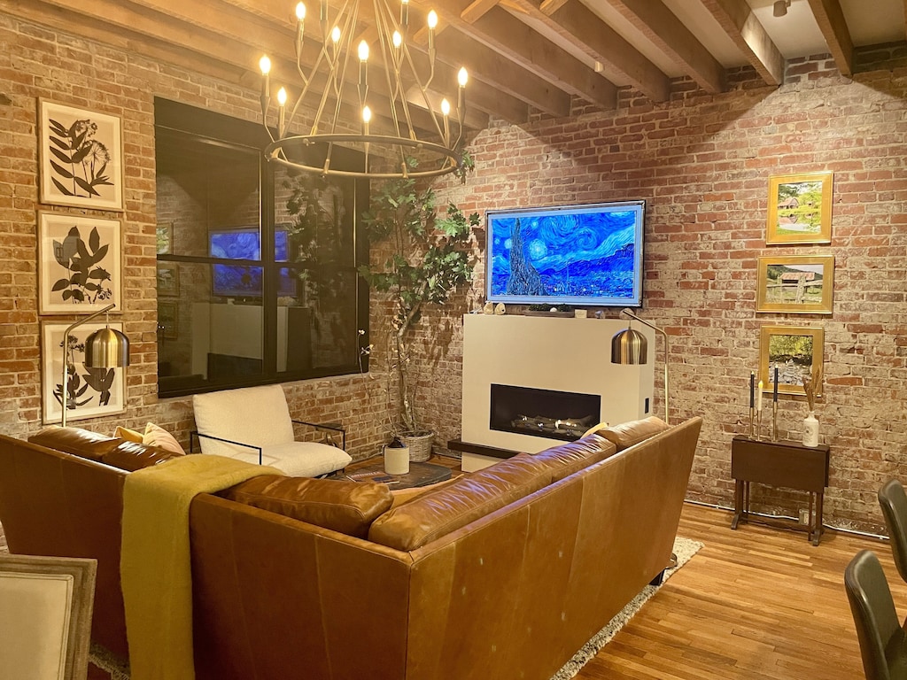 Stunning exposed brick with cozy seating and 65" LG OLED TV