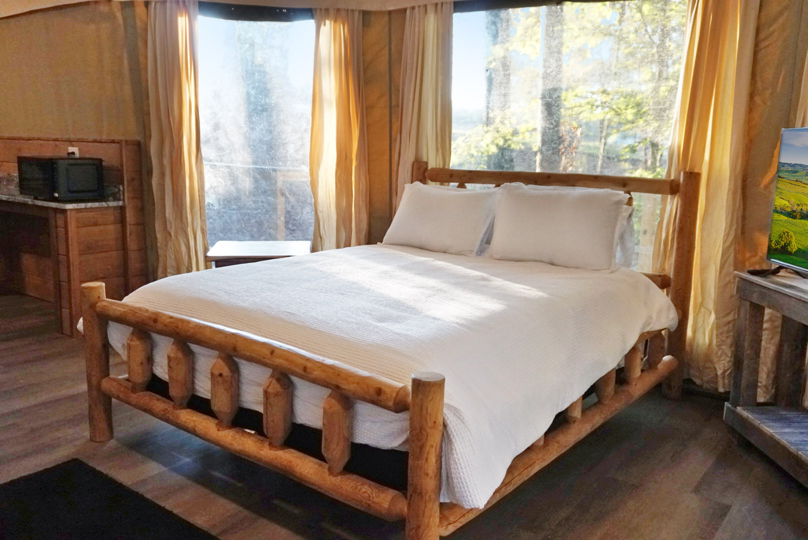 Enjoy sunlit mornings and nature views from this stylish wooden bed haven!